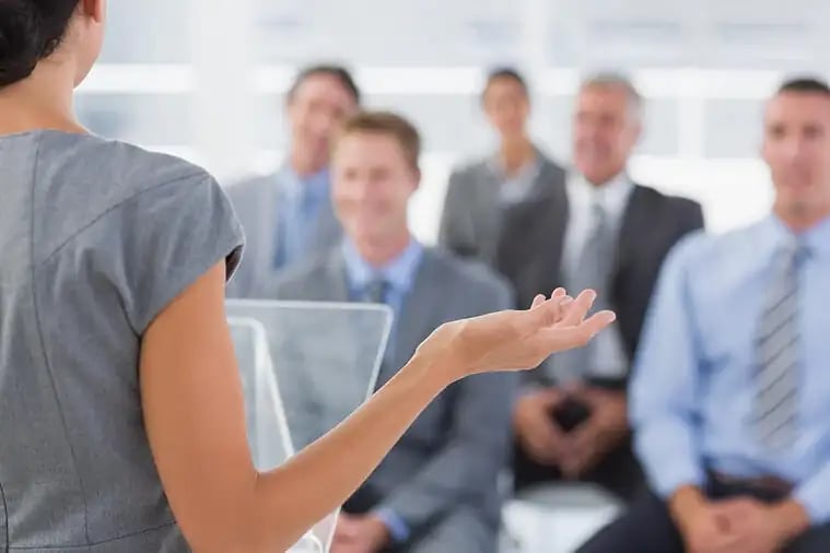 Businesswoman doing conference presentation in meeting room 7 ways Train the Trainer courses can help care providers training benefits