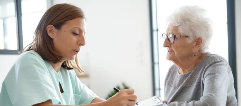 Care worker listens to patients concerns