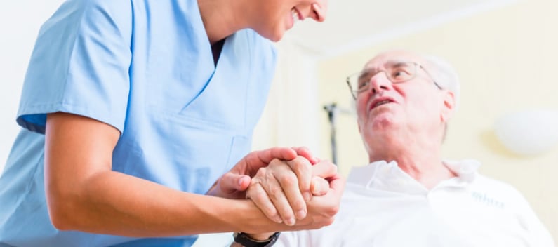 Carer listening to elderly patient