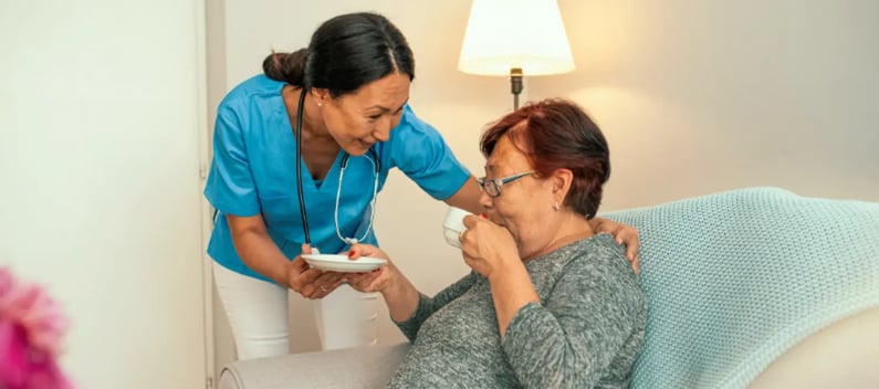 Carer showing patient respect in care home
