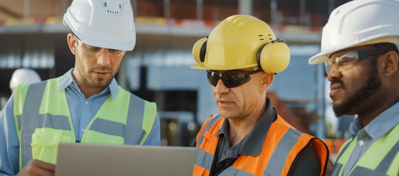 Construction workers discussing site risks