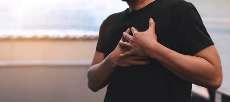 Man clutching his chest during possible heart attack